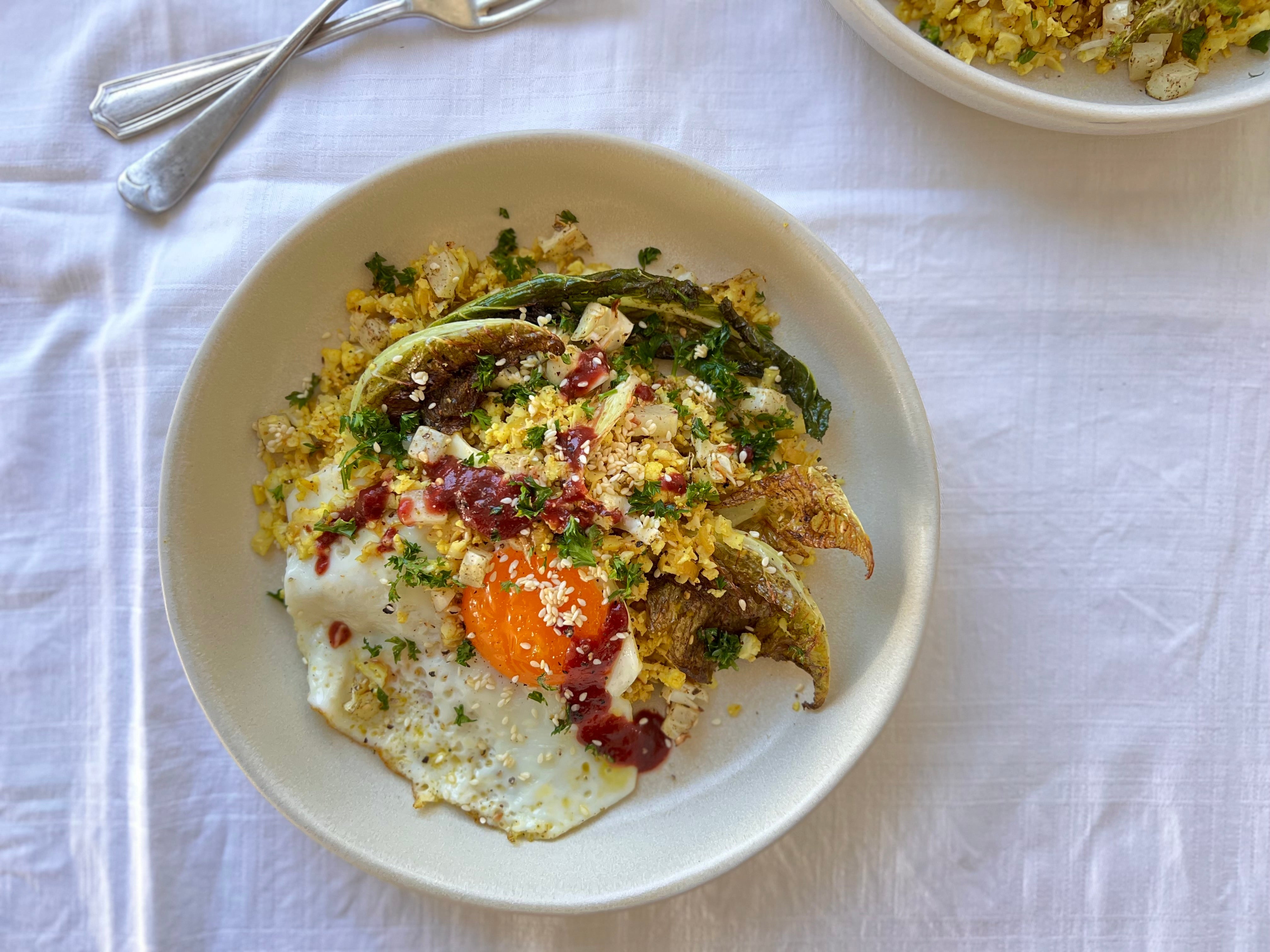 Persian spiced cauliflower rice with fried eggs and plum sauce